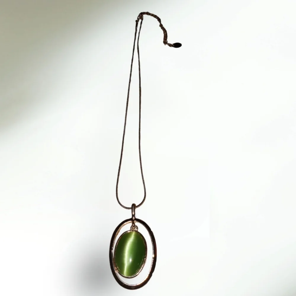 Claire's silver necklace with a green cat's eye pendant